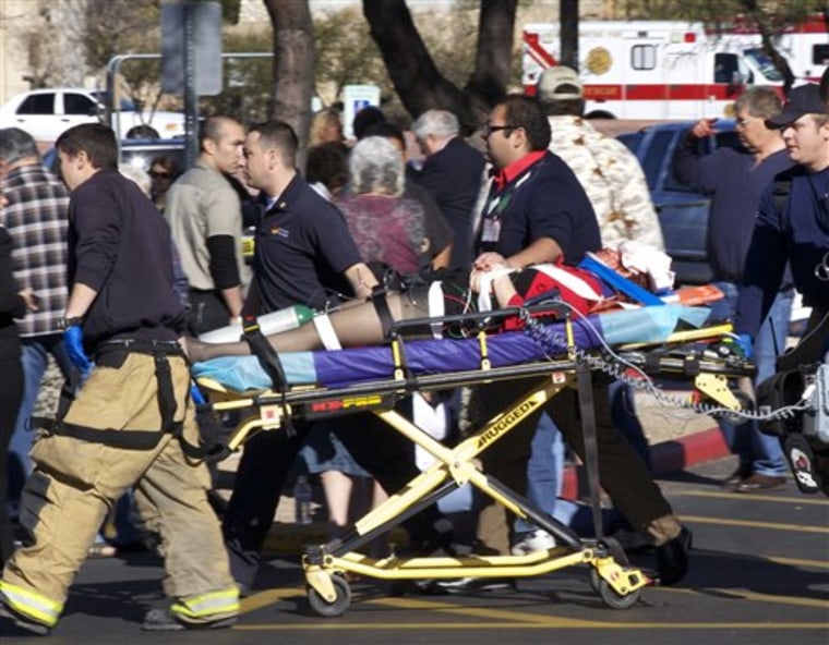 Emergency personnel move Rep. Gabrielle Goffords, D-Ariz., after she was shot in the head outside a shopping center in Tucson, Ariz., Jan. 8.